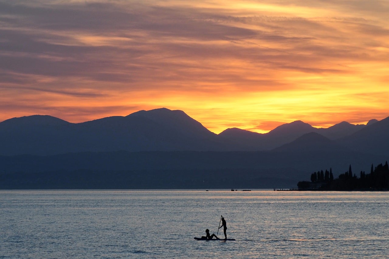 Sunset, lake, couple, paddling, dusk, romantic, red sky, mountains, silhouette, water sport, tranquility, nature, blue, evening, rowing, silence, evening sky, calm water, fiery sunset, symmetry