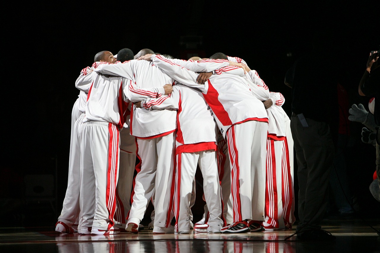 Pro basketball team, huddle, basketball players, pre-game, uniforms, game, sport, american, athlete, performance, group, men, athletics, sportswear, court, arena, floor, pep talk, professional, male,