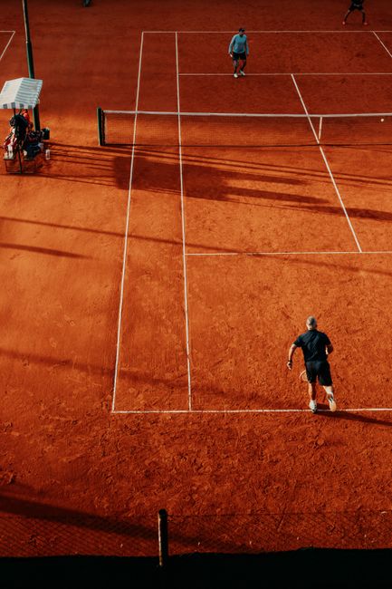 Aerial view of players in action on a clay tennis court in Buenos Aires, Argentina.