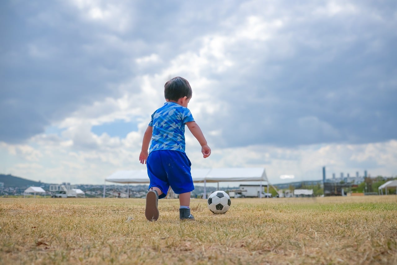 Football, child, kick, meadow, playing, leisure, running, boy, playground, artificial grass, cloudless, blue clothing, child's play, outdoor activities, shoe, nature, clouds, joy, fun, childhood, natu