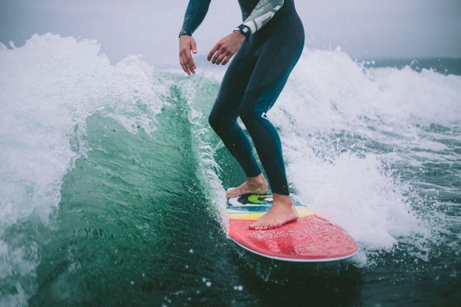 Close-up of a surfer expertly riding waves on a wakesurf board. Energetic and adventurous.