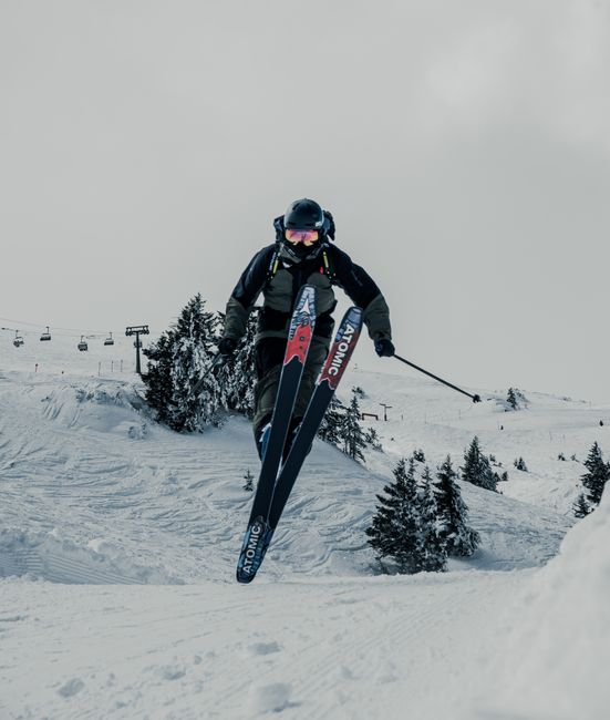 A skier in action on snowy slopes of Graubünden, showcasing thrilling winter sports in Switzerland.