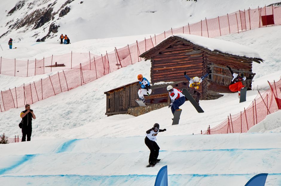 Action-packed snowboarding scene at Swiss ski resort in Arosa during winter.