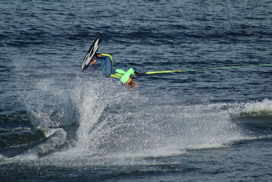 A thrilling aerial maneuver performed during water skiing in open waters.