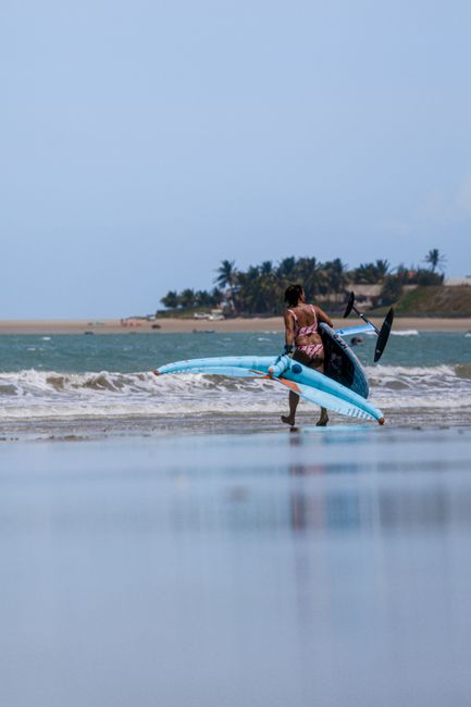 A woman wing foiling on the picturesque Icaraí Beach in Brazil.