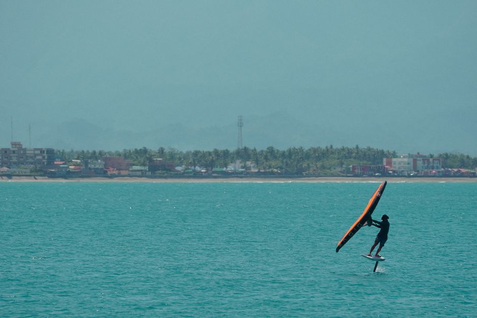 A thrilling display of wing foiling in Baler, Philippines captures the essence of adventure sports.