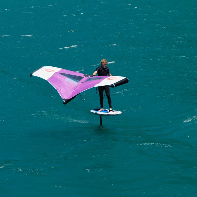 Exciting wingfoil action on turquoise waters, perfect for adventure enthusiasts.