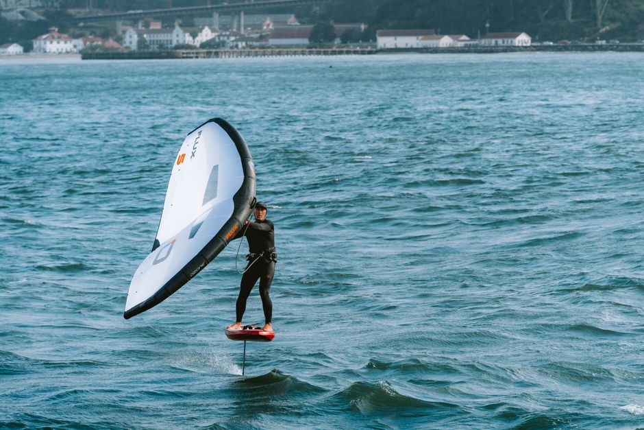 A thrilling scene of a person wing foiling in San Francisco Bay, showcasing the dynamic sport on the water.